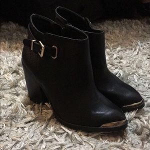 Black booties with gold trim